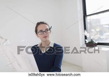 Young woman with blueprint View Large Photo Image Stock Photo - Young woman with blueprint. Fotosearch