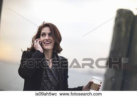 Young woman with cellphone and coffee next to Hudson river, New York, USA View Large Photo Image Stock Image - Young woman with cellphone and coffee next to Hudson river, New York, USA. Fotosearch