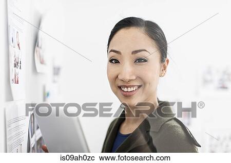 Stock Image - Young woman with digital tablet. Fotosearch
