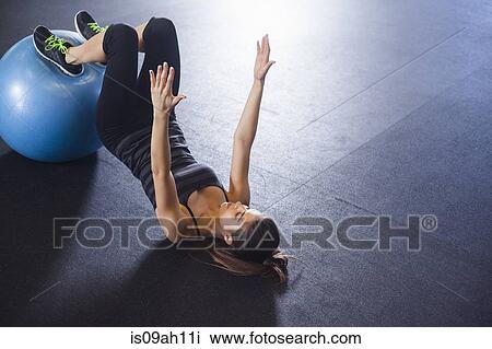 Young woman working out with gym ball View Large Photo Image Stock Image - Young woman working out with gym ball. Fotosearch