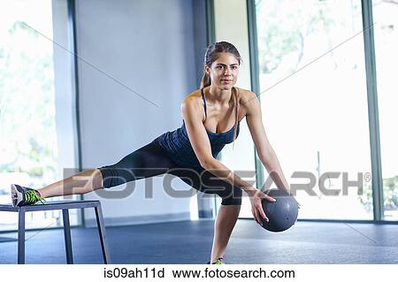 Young woman working out with medicine ball View Large Photo Image Stock Image - Young woman working out with medicine ball. Fotosearch