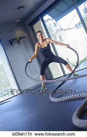Young woman working out with rope View Large Photo Image Stock Image - Young woman working out with rope. Fotosearch
