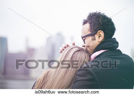 Affectionate young couple and Manhattan skyline, New York, USA View Large Photo Image Stock Photo - Affectionate young couple and Manhattan skyline, New York, USA. Fotosearch