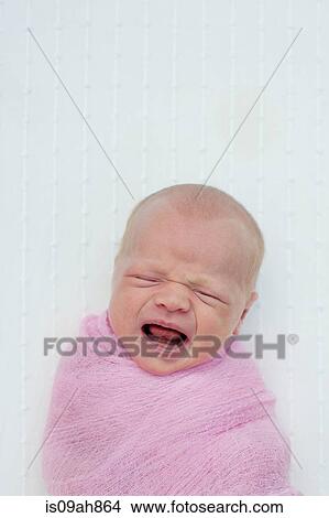 Baby crying, wrapped in blanket View Large Photo Image Picture - Baby crying, wrapped in blanket. Fotosearch