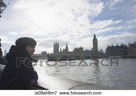 Boy by River Thames, Palace of Westminster in background, London View Large Photo Image Stock Photo - Boy by River Thames, Palace of Westminster in background, London. Fotosearch