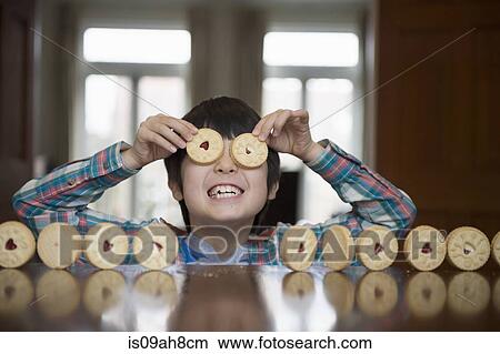 Boy playing with biscuits View Large Photo Image Picture - Boy playing with biscuits. Fotosearch