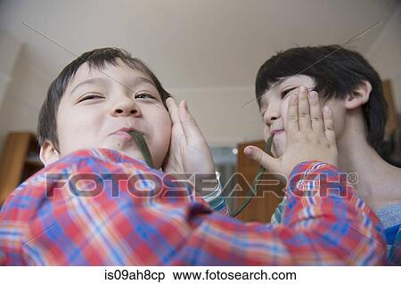 Brothers eating gummy snake View Large Photo Image Stock Photography - Brothers eating gummy snake. Fotosearch