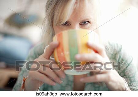 Picture - Close up of mature woman drinking coffee. Fotosearch