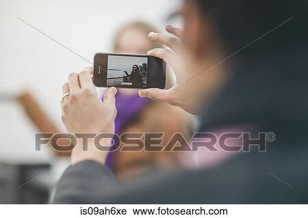 Close up of young man photographing girlfriend on camera phone View Large Photo Image Stock Image - Close up of young man photographing girlfriend on camera phone. Fotosearch