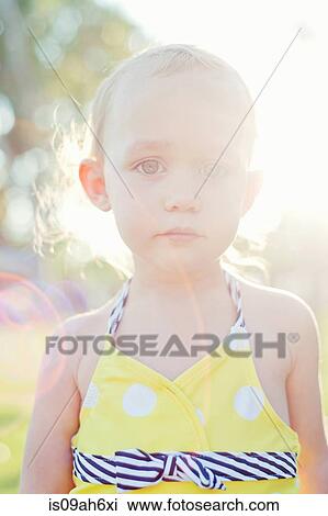 Stock Image - Close up portrait of backlit female toddler. Fotosearch