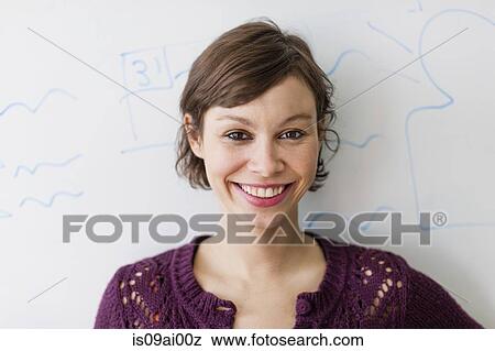 Close up portrait of young woman in front of whiteboard View Large Photo Image Stock Photo - Close up portrait of young woman in front of whiteboard. Fotosearch