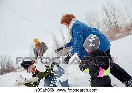 Stock Image - Family having snowball fight. Fotosearch