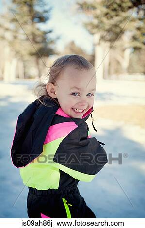 Girl in snow, looking over shoulder View Large Photo Image Stock Image - Girl in snow, looking over shoulder. Fotosearch