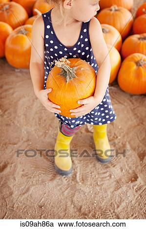 Girl picking pumpkin View Large Photo Image Stock Image - Girl picking pumpkin. Fotosearch