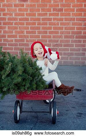 Girl sitting in trailer with christmas tree View Large Photo Image Stock Image - Girl sitting in trailer with christmas tree. Fotosearch