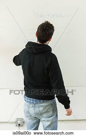 Picture - Male designer drawing on whiteboard in studio. Fotosearch