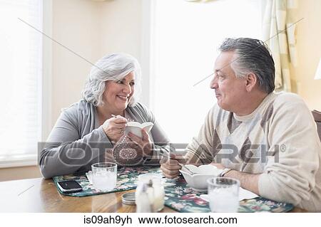 Mature couple at home having lunch View Large Photo Image Stock Image - Mature couple at home having lunch. Fotosearch