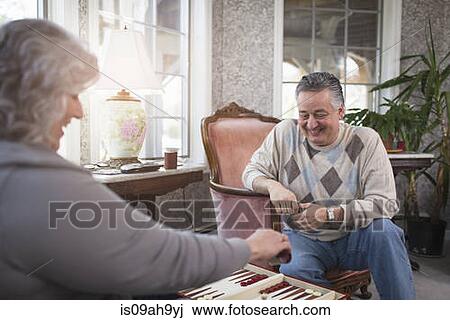 Mature couple at home playing backgammon View Large Photo Image Stock Image - Mature couple at home playing backgammon. Fotosearch