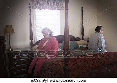 Mature couple sitting on opposite sides of bed View Large Photo Image Stock Image - Mature couple sitting on opposite sides of bed. Fotosearch