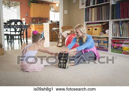 Mother and young daughter warming up for ballet in sitting room View Large Photo Image Stock Image - Mother and young daughter warming up for ballet in sitting room. Fotosearch