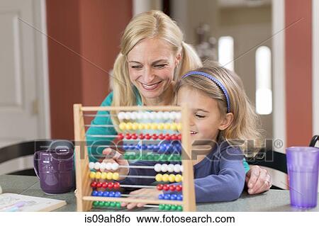 Picture - Mother and young daughter with abacus. Fotosearch