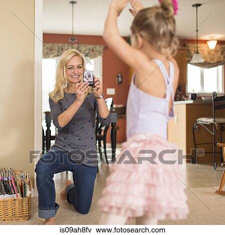 Mother photographing daughter in ballet pose View Large Photo Image Stock Photo - Mother photographing daughter in ballet pose. Fotosearch