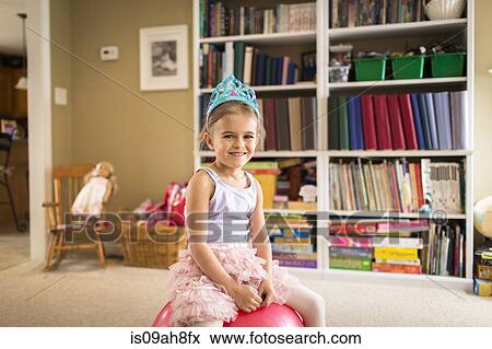 Portrait of cute young girl sitting on exercise ball View Large Photo Image Stock Photo - Portrait of cute young girl sitting on exercise ball. Fotosearch