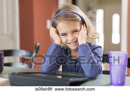 Portrait of cute young girl with digital tablet View Large Photo Image Stock Image - Portrait of cute young girl with digital tablet. Fotosearch