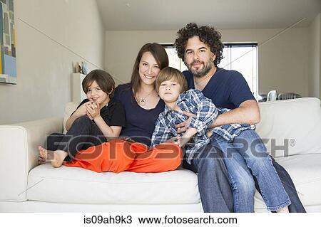Portrait of family with two boys on sofa View Large Photo Image Stock Image - Portrait of family with two boys on sofa. Fotosearch
