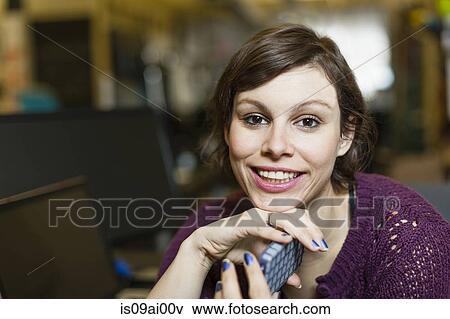 Stock Photo - Portrait of female designer with smartphone. Fotosearch