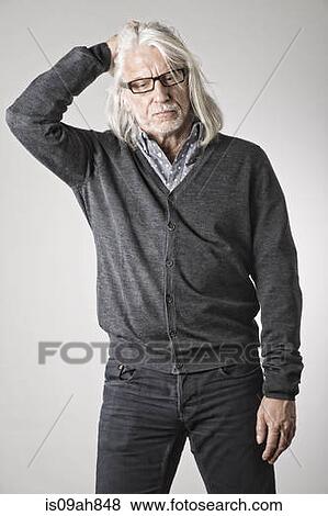 Portrait of mature man, hand on head View Large Photo Image Stock Photo - Portrait of mature man, hand on head. Fotosearch