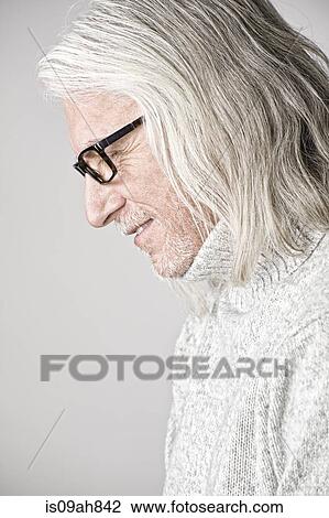 Stock Image - Portrait of mature man, side view, looking down. Fotosearch