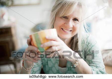 Portrait of mature woman with coffee cup View Large Photo Image Stock Photography - Portrait of mature woman with coffee cup. Fotosearch