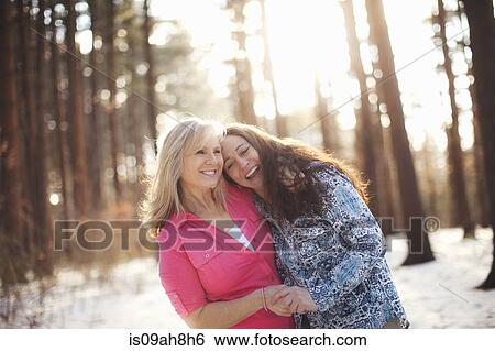 Portrait of mature women hugging in forest View Large Photo Image Stock Photograph - Portrait of mature women hugging in forest. Fotosearch