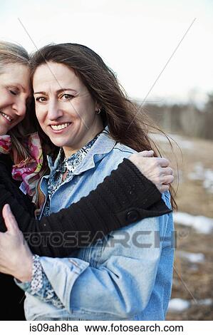 Portrait of mature women hugging outdoors View Large Photo Image Stock Image - Portrait of mature women hugging outdoors. Fotosearch