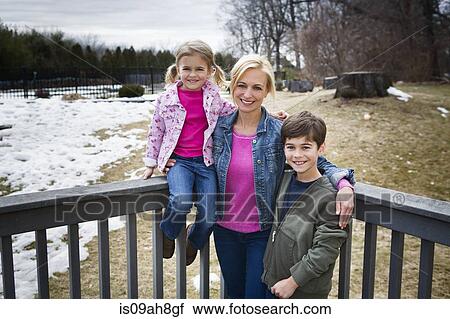 Portrait of mother and two children in park View Large Photo Image Stock Image - Portrait of mother and two children in park. Fotosearch