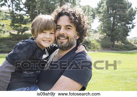 Stock Photography - Portrait of proud father and son in park. Fotosearch
