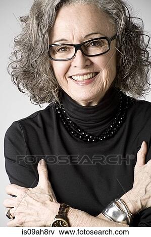 Stock Photo - Portrait of senior woman, arms folded. Fotosearch