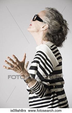 Portrait of senior woman, arms open, side view View Large Photo Image Stock Photo - Portrait of senior woman, arms open, side view. Fotosearch