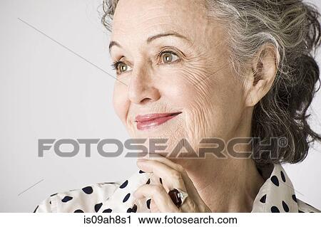 Portrait of senior woman, hand on chin, smiling View Large Photo Image Stock Image - Portrait of senior woman, hand on chin, smiling. Fotosearch