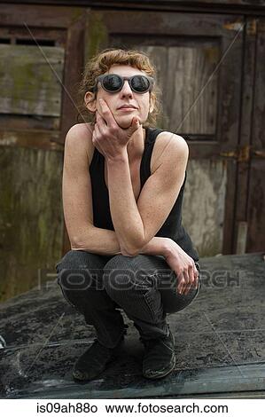 Portrait of woman in sunglasses on car bonnet View Large Photo Image Picture - Portrait of woman in sunglasses on car bonnet. Fotosearch