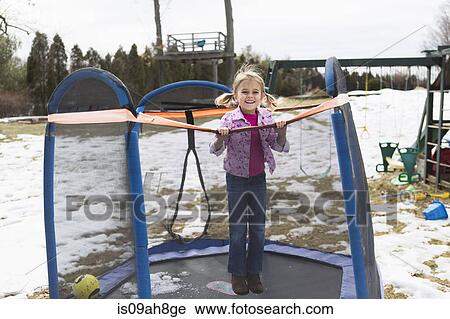 Portrait of young girl jumping on trampoline in park View Large Photo Image Stock Image - Portrait of young girl jumping on trampoline in park. Fotosearch