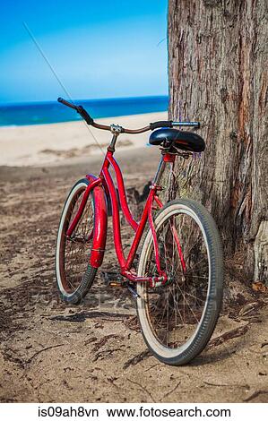 Red bicycle parked on beach, Kaua'i, Hawaii, USA View Large Photo Image Picture - Red bicycle parked on beach, Kaua'i, Hawaii, USA. Fotosearch