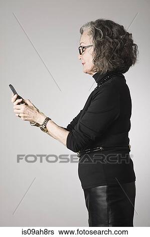 Stock Photograph - Senior woman using smartphone. Fotosearch