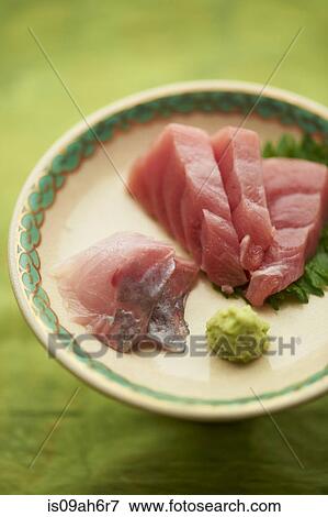 Still life of raw sliced fish dish with leaves View Large Photo Image Stock Photo - Still life of raw sliced fish dish with leaves. Fotosearch