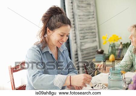 Two mature female artists painting watercolour in studio View Large Photo Image Stock Photograph - Two mature female artists painting watercolour in studio. Fotosearch