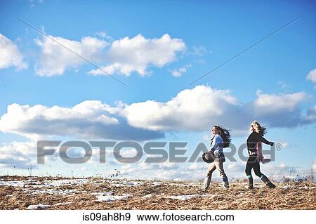 Stock Photo - Two mature women enjoying exhilarating walk. Fotosearch