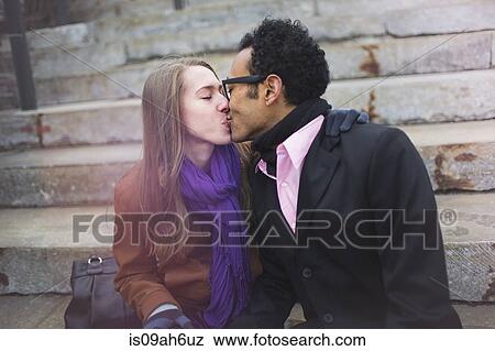 Young couple kissing on urban steps View Large Photo Image Stock Photo - Young couple kissing on urban steps. Fotosearch