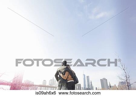 Stock Photograph - Young couple next to Brooklyn Bridge, New York, USA. Fotosearch