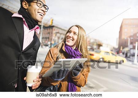 Young couple using digital tablet in New York, USA View Large Photo Image Stock Photo - Young couple using digital tablet in New York, USA. Fotosearch